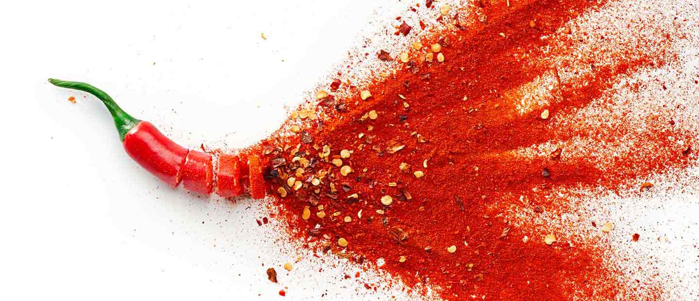Chili pepper and chili powder bursting out